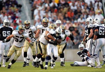 SHREVEPORT, LA - AUGUST 21:  Running back Julius Jones #21 of the Dallas Cowboys is tackled by Rob Ninkovich #93 of the New Orleans Saints during a preseason game on August 21, 2006 at Independence Stadium in Shreveport, Louisiana.  (Photo by Ronald Martinez/Getty Images)