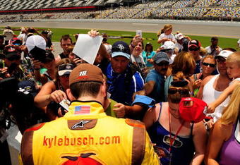 DAYTONA BEACH, FL - JULY 04:  Kyle Busch, driver of the #02 Waste Management Chip Ganassi Racing with Felix Sabates Lexus Riley, signs autographs for fans prior to the Rolex Grand-Am Sports Car Series Brumos Porsche 250 at Daytona International Speedway on July 4, 2008 in Daytona Beach, Florida.  (Photo by Rusty Jarrett/Getty Images for NASCAR)
