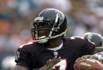 30 Dec 2001: Michael Vick # 7 of the Atlanta Falcons looks for an open man down field against the Miami Dolphins in the second quarter at Pro Player Stadium in Miami Florida. DIGITAL IMAGE. Mandatory Credit: Eliot Schechter/Getty Images