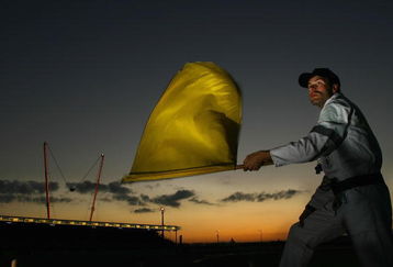 LE MANS, FRANCE - JUNE 16:  A marshall waves a yellow flag during the Le Mans 24 Hour race at the Circuit des 24 Heures du Mans June 16, 2007 in Le Mans, France.  (Photo by Ryan Pierse/Getty Images)