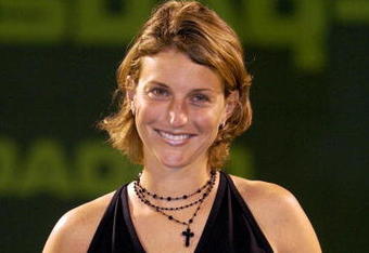 MIAMI-MARCH 21: Corina Morariu poses for photographers after being presented by the WTA with the Comeback Player of the Year award during the Nasdaq-100 Open March 21, 2003 at the Tennis Center at Crandon Park in Miami, Florida. (Photo by Ezra Shaw/Getty Images)