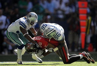 IRVING, TX - OCTOBER 26:  Tight end Jerramy Stevens #86 of the Tampa Bay Buccaneers is tackled by Bradie James #56 and Mike Jenkins #31 of the Dallas Cowboys at Texas Stadium on October 26, 2008 in Irving, Texas.  (Photo by Ronald Martinez/Getty Images)