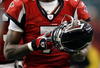 ATLANTA - DECEMBER 24:   Quarterback Michael Vick #7 of the Atlanta Falcons walks off against the Carolina Panthers December 24, 2006 at The Georgia Dome  in Atlanta,Georgia  (Photo by Marc Serota/Getty Images)
