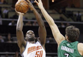 CHARLOTTE, NC - MARCH 16:  Emeka Okafor #50 of the Charlotte Bobcats takes a shot against Andrea Bargnani #7 of the Toronto Raptors during their game at Time Warner Cable Arena on March 16, 2009 in Charlotte, North Carolina.  NOTE TO USER: User expressly acknowledges and agrees that, by downloading and/or using this Photograph, user is consenting to the terms and conditions of the Getty Images License Agreement. (Photo by: Streeter Lecka/Getty Images)