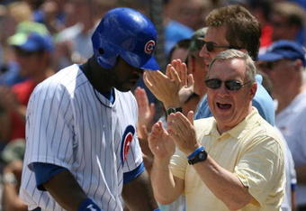 CHICAGO - JULY 26: Senator Richard Durbin (D-IL) joins Chicago Cub fans in cheering Milton Bradley #21 after Bradley scored a run on a play at the plate in the 3rd inning against the Cincinnati Reds on July 26, 2009 at Wrigley Field in Chicago, Illinois. (Photo by Jonathan Daniel/Getty Images)