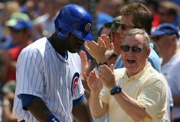 CHICAGO - JULY 26: Senator Richard Durbin (D-IL) joins Chicago Cub fans in cheering Milton Bradley #21 after Bradley scored a run on a play at the plate in the 3rd inning against the Cincinnati Reds on July 26, 2009 at Wrigley Field in Chicago, Illinois. (Photo by Jonathan Daniel/Getty Images)
