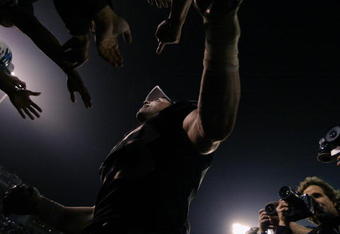 OAKLAND, CA - JANUARY 19:  Linebacker Bill Romanowski #53 of the Oakland Raiders slaps hands with the fans in the Black Hole after defeating the Tennessee Titans in the AFC Championship game at Network Associates Coliseum January 19, 2003 in Oakland, California.  The Raiders defeated the Titans 41-24, sending them on to the NFL title game for the first time since 1984.  (Photo by Brian Bahr/Getty Images)