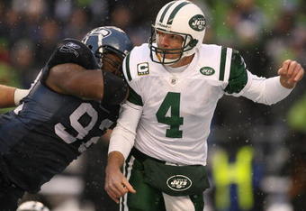 SEATTLE - DECEMBER 21:  Quarterback Brett Favre #4 of the New York Jets is hit after passing by Brandon Mebane #92 of the Seattle Seahawks on December 21, 2008 at Qwest Field in Seattle, Washington. The Seahawks defeated the Jets 13-3.(Photo by Otto Greule Jr/Getty Images)