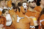 AUSTIN, TX - NOVEMBER 27:  A Texas Longhorn fan cheers on his team against the Texas A&M Aggies with a painted-on reminder of Texas score against Oklahoma earlier in the season at Darrell K Royal-Texas Memorial Stadium November 27, 2008 in Austin, Texas.  (Photo by Brian Bahr/Getty Images)