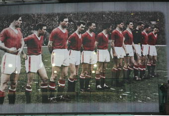 MANCHESTER, UNITED KINGDOM - JANUARY 18:  A statue of Sir Matt Busby stands in front of a giant mural commemorating the famous Busby Babes on the front of Manchester United's football stadium at Old Trafford on January 18, 2008, Manchester, England. Manchester United fans will be marking 50 years since the Munich diisaster with various events in the UK and Munich. The mural depicts the United team lining up before their European Cup game with Red Star Belgrade before the disaster at Munich airport on February 6, 1958 which claimed 23 of the 44 passengers on board.  (Photo by Christopher Furlong/Getty Images)