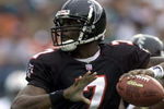 30 Dec 2001: Michael Vick # 7 of the Atlanta Falcons looks for an open man down field against the Miami Dolphins in the second quarter at Pro Player Stadium in Miami Florida. DIGITAL IMAGE. Mandatory Credit: Eliot Schechter/Getty Images