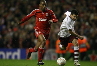 LIVERPOOL, UNITED KINGDOM - APRIL 08:  Ryan Babel of Liverpool surges past Cesc Fabregas of Arsenal on the way to scoring his team's fourth goal during the UEFA Champions League Quarter Final, second leg match between Liverpool and Arsenal at Anfield on April 8, 2008 in Liverpool, England.  (Photo by Clive Brunskill/Getty Images)
