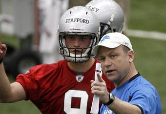ALLEN PARK, MI - MAY 01:  Offensive coordinator Scott Linehan of the Detroit Lions talks with Matthew Stafford #9 during rookie orientation camp at the Detroit Lions Headquarters and Training Facility on May 1, 2009 in Allen Park, Michigan.  (Photo by Gregory Shamus/Getty Images)