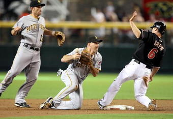 PHOENIX - JULY 25:  Infielder Jack Wilson #2 of the Pittsburgh Pirates bobbles the ball after getting the force out on Stephen Drew #6 of the Arizona Diamondbacks during the first inning of the major league baseball game at Chase Field on July 25, 2009 in Phoenix, Arizona.  (Photo by Christian Petersen/Getty Images)