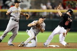 PHOENIX - JULY 25:  Infielder Jack Wilson #2 of the Pittsburgh Pirates bobbles the ball after getting the force out on Stephen Drew #6 of the Arizona Diamondbacks during the first inning of the major league baseball game at Chase Field on July 25, 2009 in Phoenix, Arizona.  (Photo by Christian Petersen/Getty Images)
