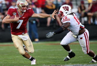 ORLANDO, FL - DECEMBER 27:  Christian Ponder #7 of the Florida State Seminoles attempts to avoid the tackle of Culmer St. Jean #15 of the Wisconsin Badgers during the Champs Bowl on December 27, 2008 at the Citrus Bowl in Orlando, Florida.  (Photo by Sam Greenwood/Getty Images)
