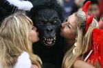 HONG KONG, CHINA - MARCH 28:  Rugby fans kiss a fellow spectator wearing a gorilla mask during the Hong Kong Rugby Sevens 2008 on March 28, 2008 in Hong Kong, China.   (Photo by MN Chan/Getty Images)