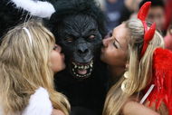 HONG KONG, CHINA - MARCH 28: Rugby fans kiss a fellow spectator wearing a gorilla mask during the Hong Kong Rugby Sevens 2008 on March 28, 2008 in Hong Kong, China. (Photo by MN Chan/Getty Images)