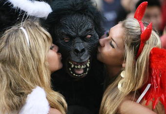 HONG KONG, CHINA - MARCH 28:  Rugby fans kiss a fellow spectator wearing a gorilla mask during the Hong Kong Rugby Sevens 2008 on March 28, 2008 in Hong Kong, China.   (Photo by MN Chan/Getty Images)