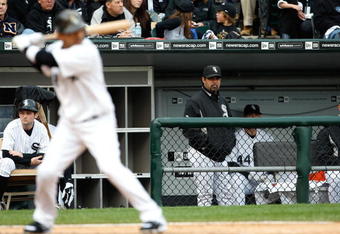 CHICAGO - OCTOBER 05:  Manager Ozzie Guillen #13 of the Chicago White Sox looks on as Orlando Cabrera #18 bats against the Tampa Bay Rays in Game Three of the ALDS during the 2008 MLB Playoffs at U.S. Cellular Field on October 5, 2008 in Chicago, Illinois.  (Photo by Jamie Squire/Getty Images)
