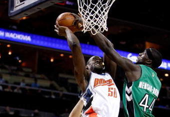 CHARLOTTE, NC - MARCH 16:  Pops Mensah-Bonsu #44 of the Toronto Raptors tries to block Emeka Okafor #50 of the Charlotte Bobcats during their game at Time Warner Cable Arena on March 16, 2009 in Charlotte, North Carolina.  NOTE TO USER: User expressly acknowledges and agrees that, by downloading and/or using this Photograph, user is consenting to the terms and conditions of the Getty Images License Agreement.  (Photo by Streeter Lecka/Getty Images)