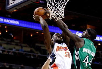 CHARLOTTE, NC - MARCH 16:  Pops Mensah-Bonsu #44 of the Toronto Raptors tries to block Emeka Okafor #50 of the Charlotte Bobcats during their game at Time Warner Cable Arena on March 16, 2009 in Charlotte, North Carolina.  NOTE TO USER: User expressly acknowledges and agrees that, by downloading and/or using this Photograph, user is consenting to the terms and conditions of the Getty Images License Agreement.  (Photo by Streeter Lecka/Getty Images)