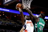 CHARLOTTE, NC - MARCH 16:  Pops Mensah-Bonsu #44 of the Toronto Raptors tries to block Emeka Okafor #50 of the Charlotte Bobcats during their game at Time Warner Cable Arena on March 16, 2009 in Charlotte, North Carolina.  NOTE TO USER: User expressly acknowledges and agrees that, by downloading and/or using this Photograph, user is consenting to the terms and conditions of the Getty Images License Agreement.  (Photo by Streeter Lecka/Getty Images)
