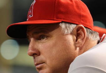 PHOENIX - JUNE 27:  Manager Mike Scioscia of the Los Angeles Angels of Anaheim watches from the dugout during the major league baseball game against the Arizona Diamondbacks at Chase Field on June 27, 2009 in Phoenix, Arizona. The Angels defeated the Diamondbacks 2-1.  (Photo by Christian Petersen/Getty Images)