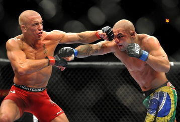 LAS VEGAS - JULY 11:  (L-R) Georges St. Pierre battles Thiago Alves during their welterweight title bout during UFC 100 on July 11, 2009 in Las Vegas, Nevada.  (Photo by Jon Kopaloff/Getty Images)