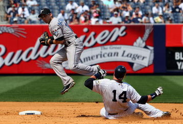 NEW YORK - JULY 06:  Eric Hinske #14 of the New York Yankees breaks up a double play against Marco Scutaro #19 of the Toronto Blue Jays on July 6, 2009 at Yankee Stadium in the Bronx borough of New York City.  (Photo by Jim McIsaac/Getty Images)