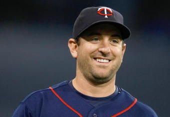 MINNEAPOLIS, MN - JULY 9:  Shortstop Nick Punto #8 of the Minnesota Twins smiles as he walks off the field against the New York Yankees at Hubert H. Humphrey Metrodome on July 9, 2008 in Minneapolis, Minnesota. The Yankees defeated the Twins 6-4. (Photo by Scott Boehm/Getty Images)