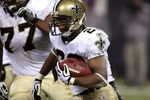 CHICAGO - DECEMBER 11:  Pierre Thomas #23 of the New Orleans Saints runs the ball against the Chicago Bears at Soldier Field on December 11, 2008 in Chicago, Illinois.  (Photo by Jonathan Daniel/Getty Images)