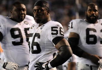 SAN DIEGO - DECEMBER 04:  Linebacker Derrick Burgess #56 of the Oakland Raiders stands with teammates during their NFL Game against the San Diego Chargers on December 4, 2008 at Qualcomm Stadium in San Diego, California.  (Photo by Harry How/Getty Images)