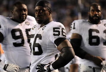 SAN DIEGO - DECEMBER 04:  Linebacker Derrick Burgess #56 of the Oakland Raiders stands with teammates during their NFL Game against the San Diego Chargers on December 4, 2008 at Qualcomm Stadium in San Diego, California.  (Photo by Harry How/Getty Images)