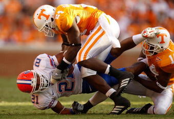 KNOXVILLE, TN - SEPTEMBER 20:  Emmanuel Moody #21 of the Florida Gators is tackled by teammates DeAngelo Willingham #24 and Eric Berry #14 of the Tennessee Volunteers during their game at Neyland Stadium on September 20, 2008 in Knoxville, Tennessee.  (Photo by Streeter Lecka/Getty Images)