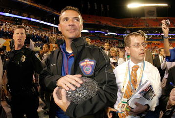 MIAMI - JANUARY 08:  Head coach Urban Meyer of the Florida Gators walks off with the National Championship trophy after their 24-14 win against the Oklahoma Sooners during the FedEx BCS National Championship game at Dolphin Stadium on January 8, 2009 in Miami, Florida.  (Photo by Doug Benc/Getty Images)