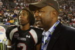 ORLANDO, FL - JANUARY 04:  Former NFL player Chris Carter, R,  and quarterback Russell Shepard #10 of the black team talk on the sideline as Carter's son Duron Carter #2 looks on during the All America Under Armour Football Game at Florida Citrus Bowl on January 4, 2009 in Orlando, Florida.  (Photo by Doug Benc/Getty Images)