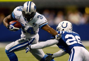 INDIANAPOLIS - DECEMBER 14:  Kevin Smith #34 of the Detroit Lions avoids a tackle by Kelvin Hayden #26 of the Indianapolis Colts on December 14, 2008 at Lucas Oil Stadium in Indianapolis, Indiana.  The Colts defeated the Lions 31-21.  (Photo by Chris Graythen/Getty Images)