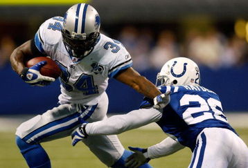 INDIANAPOLIS - DECEMBER 14:  Kevin Smith #34 of the Detroit Lions avoids a tackle by Kelvin Hayden #26 of the Indianapolis Colts on December 14, 2008 at Lucas Oil Stadium in Indianapolis, Indiana.  The Colts defeated the Lions 31-21.  (Photo by Chris Graythen/Getty Images)