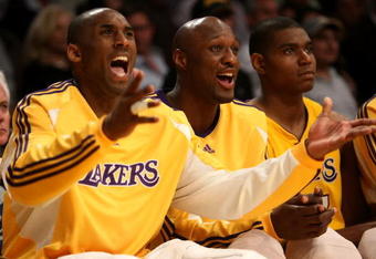 LOS ANGELES, CA - MAY 12:  (L-R) Kobe Bryant #24, Lamar Odom #7 and Andrew Bynum #17 of the Los Angeles Lakers sit on the bench late in the fourth quarter against the Houston Rockets in Game Five of the Western Conference Semifinals during the 2009 NBA Playoffs at Staples Center on May 12, 2009 in Los Angeles, California. NOTE TO USER: User expressly acknowledges and agrees that, by downloading and or using this photograph, User is consenting to the terms and conditions of the Getty Images License Agreement.  (Photo by Stephen Dunn/Getty Images)