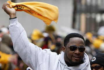 PITTSBURGH - FEBRUARY 03:  Head coach Mike Tomlin of the Pittsburgh Steelers waves a terrible towel during a parade to celebrate winning Super Bowl XLIII on February 3, 2009 in Pittsburgh, Pennsylvania.  (Photo by Gregory Shamus/Getty Images)