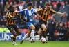 WIGAN, UNITED KINGDOM - MARCH 22:  Paul Scharner (C) of Wigan breaks past Samuel Ricketts (R) and Kamil Zayatte of Hull during the Barclays Premier League match between Wigan Athletic and Hull City at The JJB Stadium on March 22, 2009 in Wigan, England.  (Photo by Laurence Griffiths/Getty Images)