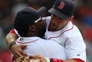 BOSTON - JULY 30:  Designated hitter David Ortiz #34 of the Boston Red Sox hugs teammate Mike Lowell #25 after the victory against the Oakland A's on July 30, 2009 at Fenway Park in Boston, Massachusetts.  (Photo by Elsa/Getty Images)