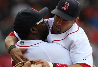 BOSTON - JULY 30:  Designated hitter David Ortiz #34 of the Boston Red Sox hugs teammate Mike Lowell #25 after the victory against the Oakland A's on July 30, 2009 at Fenway Park in Boston, Massachusetts.  (Photo by Elsa/Getty Images)
