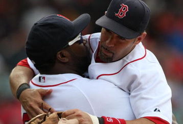 BOSTON - JULY 30:  Designated hitter David Ortiz #34 of the Boston Red Sox hugs teammate Mike Lowell #25 after the victory against the Oakland A's on July 30, 2009 at Fenway Park in Boston, Massachusetts.  (Photo by Elsa/Getty Images)