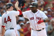 BOSTON - JULY 30: Designated hitter David Ortiz #34 of the Boston Red Sox high fives teammate Jason Bay #44 after hitting a three-run home run against the Oakland A's in the seventh inning to give the Red Sox a 6-5 lead on July 30, 2009 at Fenway Park in Boston, Massachusetts. (Photo by Elsa/Getty Images)