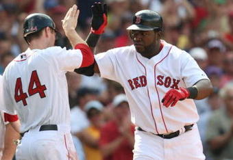 BOSTON - JULY 30:  Designated hitter David Ortiz #34 of the Boston Red Sox high fives teammate Jason Bay #44 after hitting a three-run home run against the Oakland A's in the seventh inning to give the Red Sox a 6-5 lead on July 30, 2009 at Fenway Park in Boston, Massachusetts.  (Photo by Elsa/Getty Images)