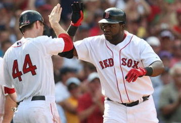 BOSTON - JULY 30:  Designated hitter David Ortiz #34 of the Boston Red Sox high fives teammate Jason Bay #44 after hitting a three-run home run against the Oakland A's in the seventh inning to give the Red Sox a 6-5 lead on July 30, 2009 at Fenway Park in Boston, Massachusetts.  (Photo by Elsa/Getty Images)