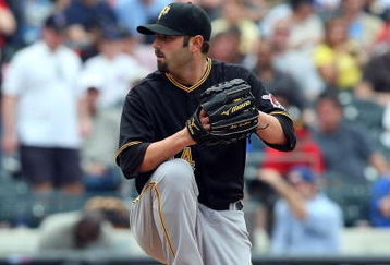NEW YORK - MAY 09:  John Grabow #34 of the Pittsburgh Pirates pitches against the New York Mets on May 9, 2009 at Citi Field in the Flushing neighborhood of the Queens borough of New York City. The Mets defeated the Pirates 10-1.  (Photo by Jim McIsaac/Getty Images)