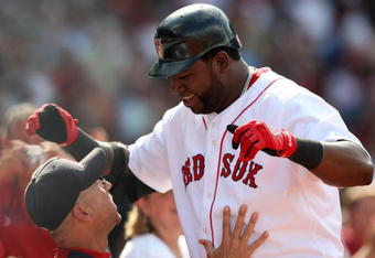 BOSTON - JULY 30:  Designated hitter David Ortiz #34 of the Boston Red Sox celebrates with manager Terry Francona #47 after hitting a three-run home run against the Oakland A's in the seventh inning to give the Red Sox a 6-5 lead on July 30, 2009 at Fenway Park in Boston, Massachusetts.  (Photo by Elsa/Getty Images)